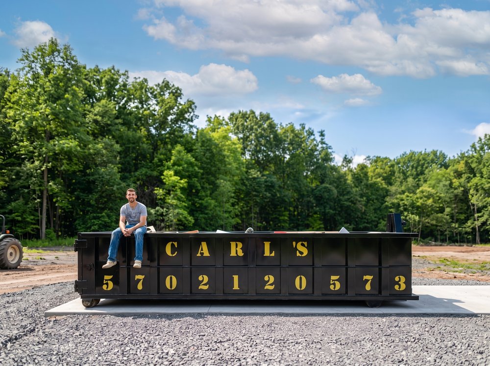 Carl Evarts standing in front of a Roll-off